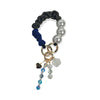 Hades handle in hand-braided TENCEL™ hanging with charm details