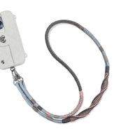 Phone strap attached to phone charging port in Mist Concerto
