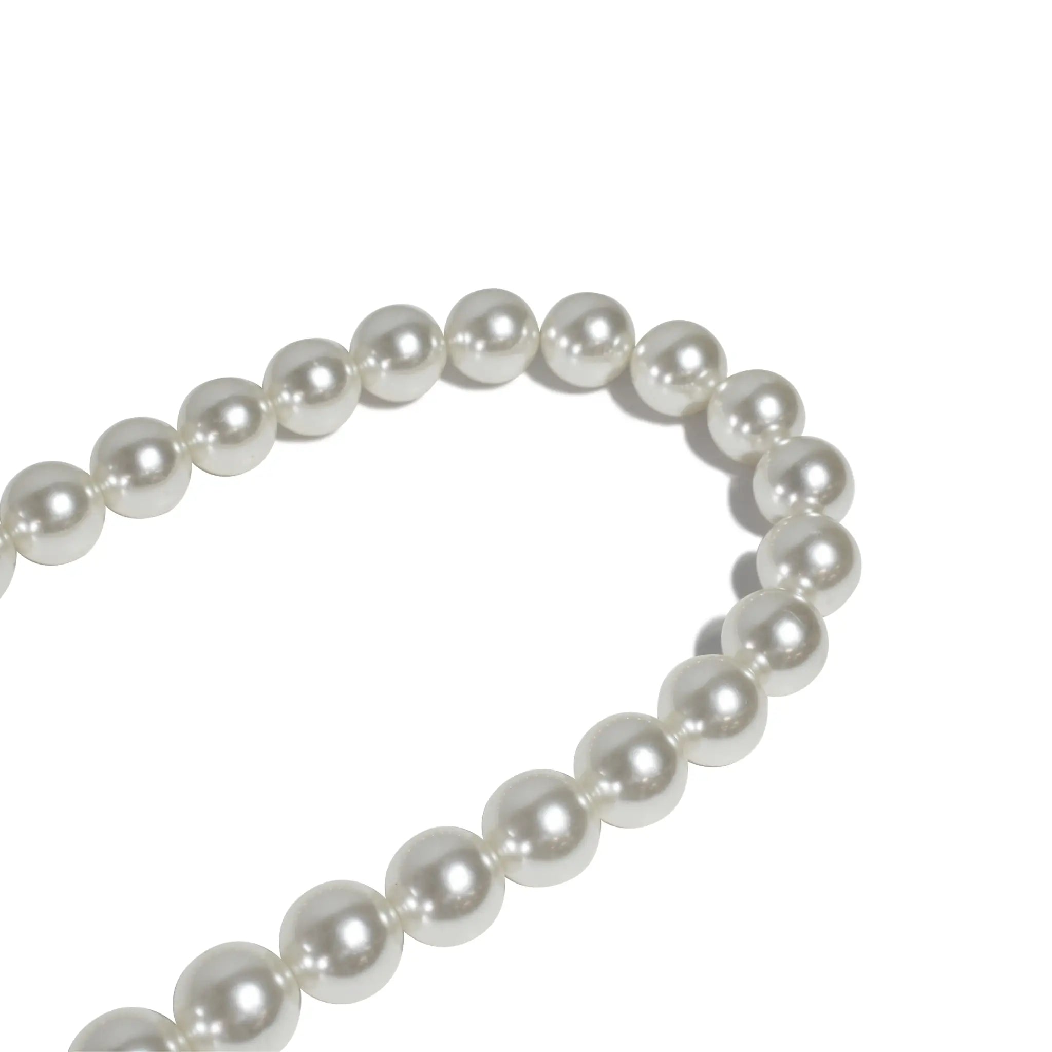 Macro shot of pearl beads on shoulder rope strap, showing fine craftsmanship.