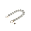 Side display of pearl wristlet strap with golden clasps separated, for secure wearing.