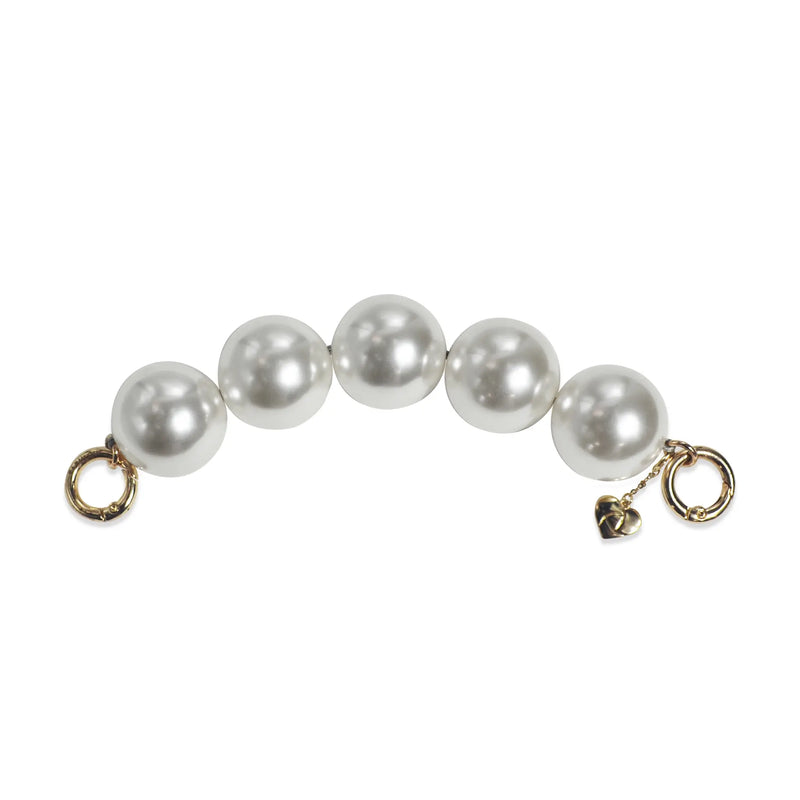 Side view of pearl handle strap with golden clasps separated, for hand or bag use.
