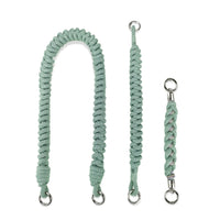 Disassembled mint green straps: Shoulder segment, wrist safety band, handle charm isolated frontal view 