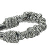 Detailed texture of shimmering crystal braids with silver hardware