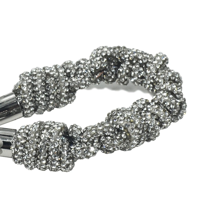 Detailed texture of shimmering crystal braids with silver hardware