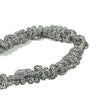 Artisanal crystal braiding detail with silver metal clasp