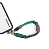 Wristlet strap attached to phone case charging port for secure hold